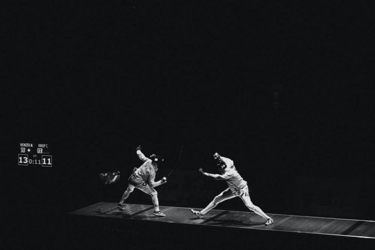 Black and white image of an Olympic fencing match